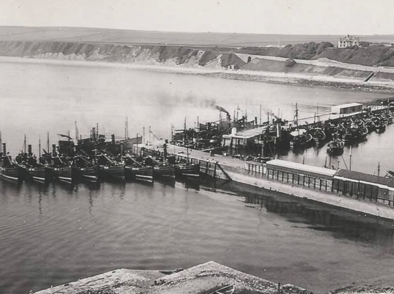 A black and white archive photo of a fleet of fishing boats